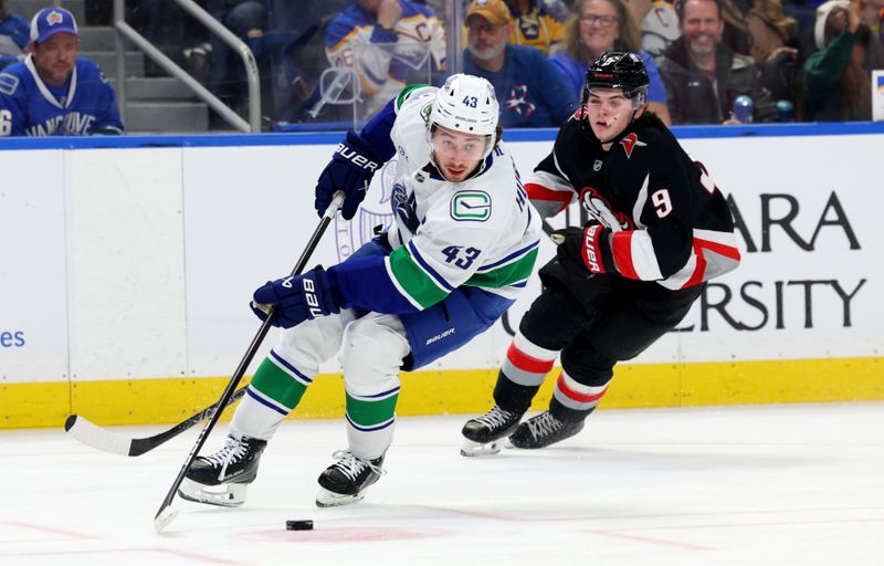 Nov 29, 2024; Buffalo, New York, USA;  Vancouver Canucks defenseman Quinn Hughes (43) skates with the puck during the second period against the Buffalo Sabres at KeyBank Center. Mandatory Credit: Timothy T. Ludwig-Imagn Images