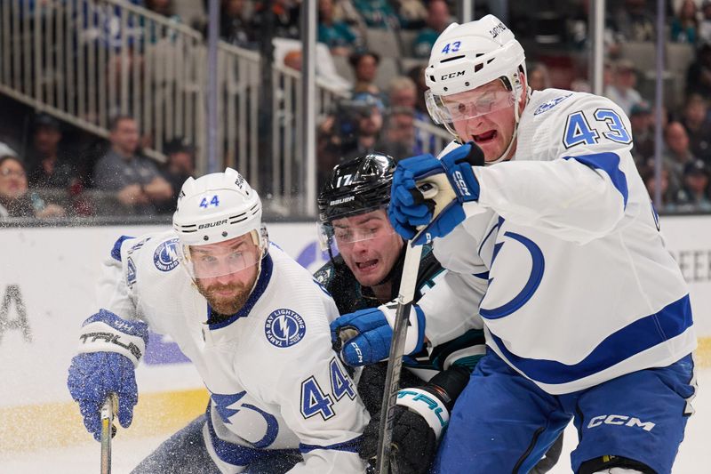 Mar 21, 2024; San Jose, California, USA; Tampa Bay Lightning defenseman Calvin de Haan (44) and defenseman Darren Raddysh (43) vie for the puck against San Jose Sharks center Thomas Bordeleau (17) during the second period at SAP Center at San Jose. Mandatory Credit: Robert Edwards-USA TODAY Sports