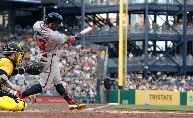 May 24, 2024; Pittsburgh, Pennsylvania, USA;  Atlanta Braves right fielder Ronald Acuna Jr. (13) hits a single against the Pittsburgh Pirates during the fourth inning at PNC Park. Mandatory Credit: Charles LeClaire-USA TODAY Sports