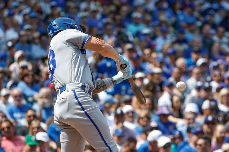 Aug 18, 2023; Chicago, Illinois, USA; Kansas City Royals center fielder Kyle Isbel (28) hits an RBI-single against the Chicago Cubs during the third inning at Wrigley Field. Mandatory Credit: Kamil Krzaczynski-USA TODAY Sports