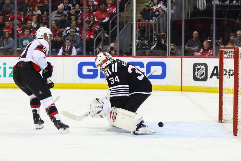 Mar 23, 2024; Newark, New Jersey, USA; Ottawa Senators right wing Mathieu Joseph (21) scores a goal on New Jersey Devils goaltender Jake Allen (34) during the first period at Prudential Center. Mandatory Credit: Ed Mulholland-USA TODAY Sports