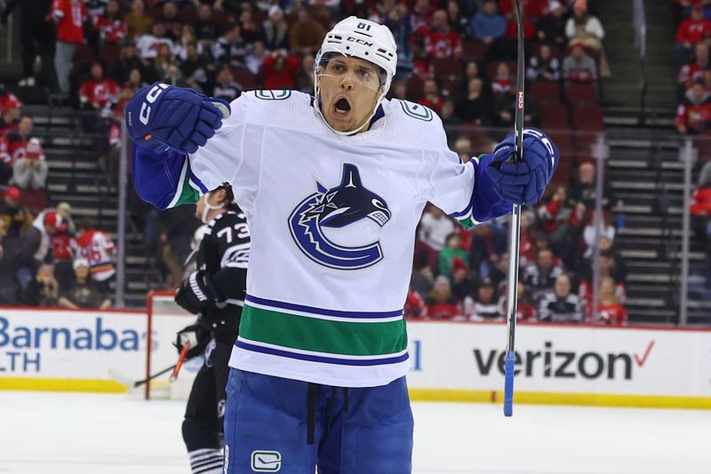 Jan 6, 2024; Newark, New Jersey, USA; Vancouver Canucks center Dakota Joshua (81) celebrates his goal against the New Jersey Devils during the third period at Prudential Center. Mandatory Credit: Ed Mulholland-USA TODAY Sports