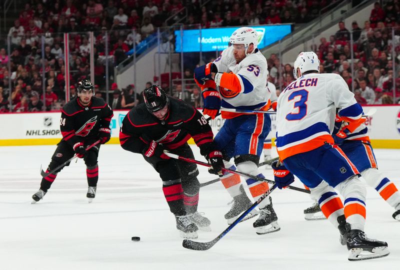 Apr 30, 2024; Raleigh, North Carolina, USA; New York Islanders center Casey Cizikas (53) checks Carolina Hurricanes center Jack Drury (18) during the first period in game five of the first round of the 2024 Stanley Cup Playoffs at PNC Arena. Mandatory Credit: James Guillory-USA TODAY Sports