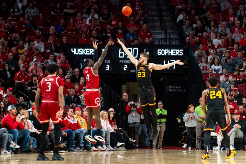 Feb 25, 2024; Lincoln, Nebraska, USA; Nebraska Cornhuskers forward Juwan Gary (4) shoots a 3-point shot against Minnesota Golden Gophers forward Parker Fox (23) during the second half at Pinnacle Bank Arena. Mandatory Credit: Dylan Widger-USA TODAY Sports