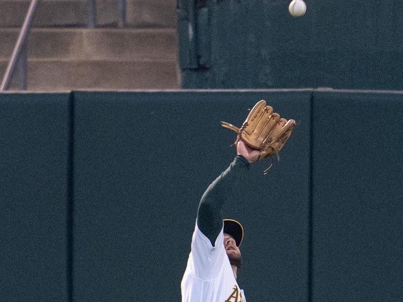 Sep 19, 2023; Oakland, California, USA; Oakland Athletics right fielder Seth Brown (15) fields a fly ball against the Seattle Mariners during the second inning at Oakland-Alameda County Coliseum. Mandatory Credit: Neville E. Guard-USA TODAY Sports