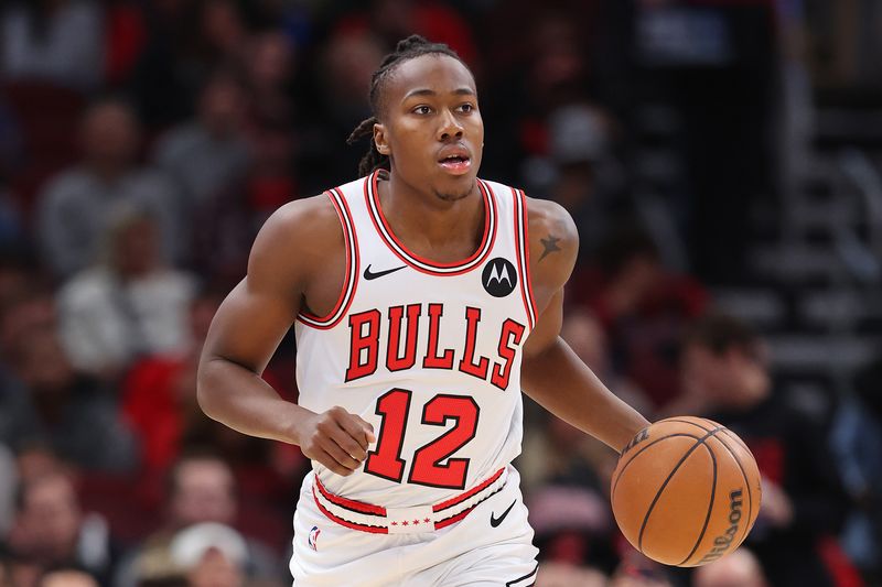 CHICAGO, ILLINOIS - NOVEMBER 06: Ayo Dosunmu #12 of the Chicago Bulls dribbles up the court against the Utah Jazz during the first half at the United Center on November 06, 2023 in Chicago, Illinois. NOTE TO USER: User expressly acknowledges and agrees that, by downloading and or using this photograph, User is consenting to the terms and conditions of the Getty Images License Agreement. (Photo by Michael Reaves/Getty Images)