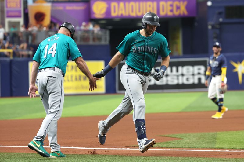 Jun 24, 2024; St. Petersburg, Florida, USA;  Seattle Mariners catcher Cal Raleigh (29) is congratulated by third base coach Manny Acta (14) after he hit a home run against the Tampa Bay Rays during the fourth inning at Tropicana Field. Mandatory Credit: Kim Klement Neitzel-USA TODAY Sports