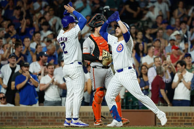 Jun 17, 2024; Chicago, Illinois, USA; Chicago Cubs first baseman Michael Busch (29) celebrates with second baseman Nico Hoerner (2) after hitting a two-run home run against the San Francisco Giants during the sixth inning at Wrigley Field. Mandatory Credit: Kamil Krzaczynski-USA TODAY Sports