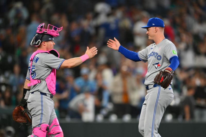 May 11, 2025; Seattle, Washington, USA; Toronto Blue Jays catcher Tyler Heineman (55) and relief pitcher Braydon Fisher (63) celebrate defeating the Seattle Mariners at T-Mobile Park. Mandatory Credit: Steven Bisig-Imagn Images