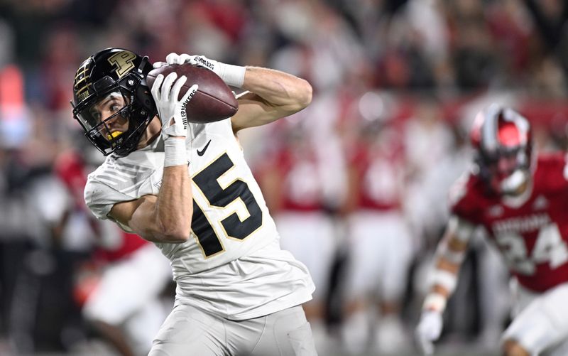 Nov 26, 2022; Bloomington, Indiana, USA;  Purdue Boilermakers wide receiver Charlie Jones (15) catches a long pass for a touchdown against the Indiana Hoosiers  during the second half at Memorial Stadium. Mandatory Credit: Marc Lebryk-USA TODAY Sports