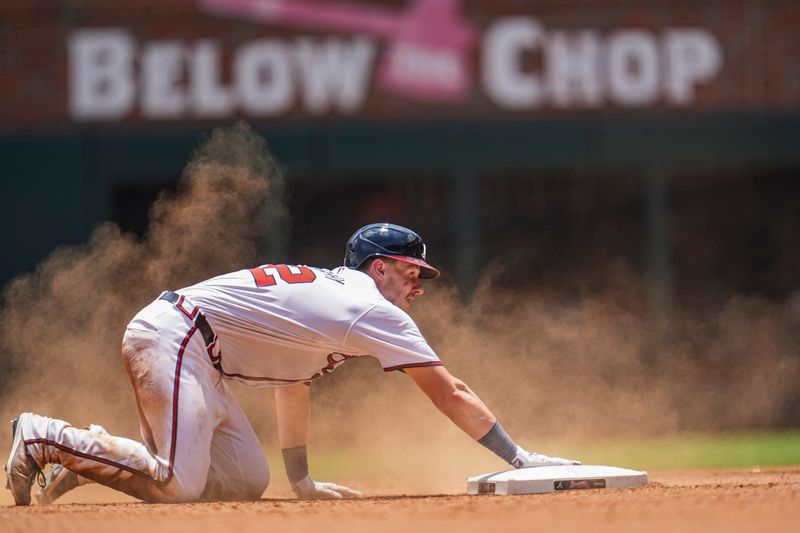 Jun 30, 2024; Cumberland, Georgia, USA; Atlanta Braves catcher Sean Murphy (12) holds on to second base after hitting a double against the Pittsburgh Pirates during the ninth inning at Truist Park. Mandatory Credit: Dale Zanine-USA TODAY Sports