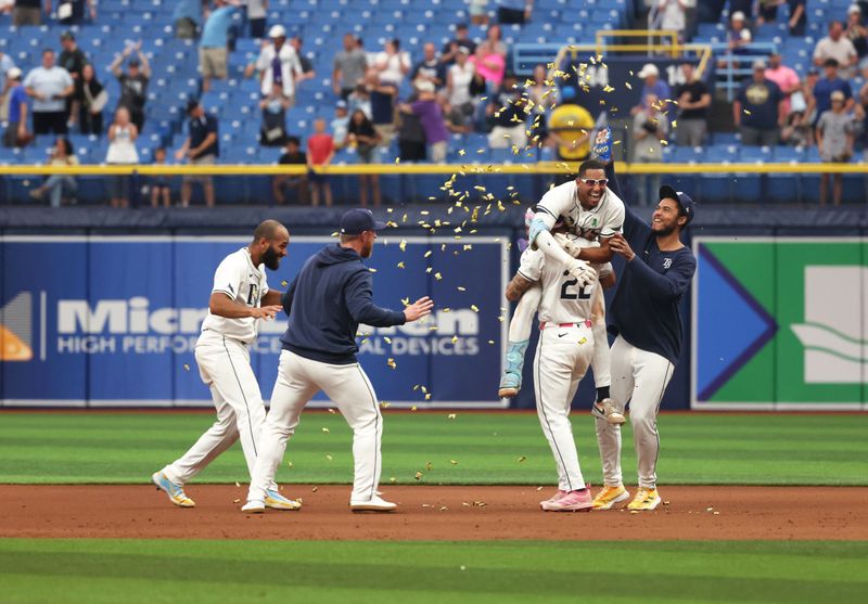 May 30, 2024; St. Petersburg, Florida, USA; Tampa Bay Rays outfielder Richie Palacios (1) celebrates with teammates after hitting a walk off RBI single against the Oakland Athletics during the eleventh inning at Tropicana Field. Mandatory Credit: Kim Klement Neitzel-USA TODAY Sports