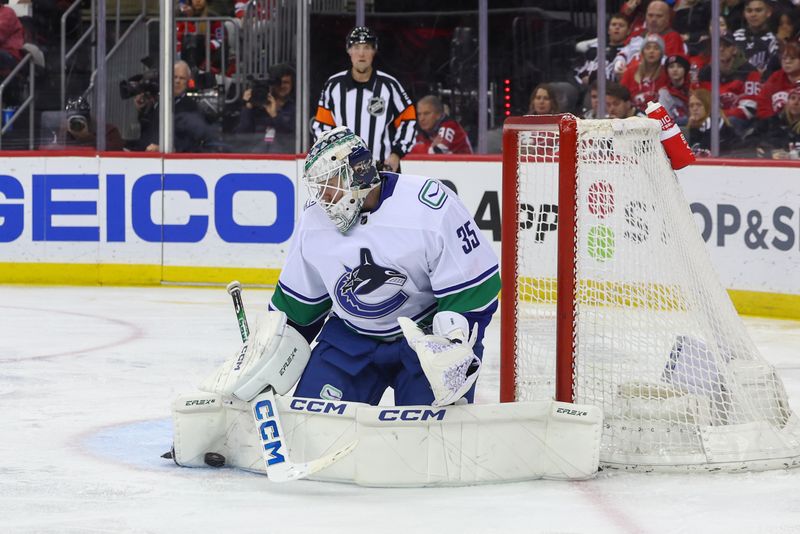 Jan 6, 2024; Newark, New Jersey, USA; Vancouver Canucks goaltender Thatcher Demko (35) makes a save against the New Jersey Devils during the second period at Prudential Center. Mandatory Credit: Ed Mulholland-USA TODAY Sports