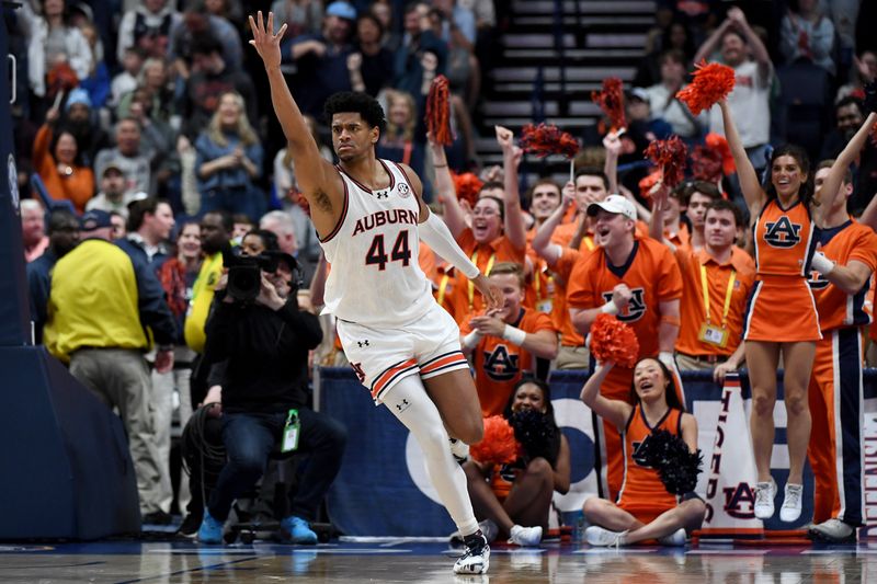 Mar 17, 2024; Nashville, TN, USA; Auburn Tigers center Dylan Cardwell (44) celebrates in the second half against the Florida Gators in the SEC Tournament championship game at Bridgestone Arena. Mandatory Credit: Christopher Hanewinckel-USA TODAY Sports