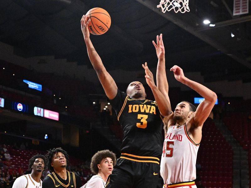 Feb 11, 2026; College Park, Maryland, USA;  Iowa Hawkeyes forward Cam Manyawu (#3) drives to the basket past Maryland Terrapins center Colin Metcalf (45) in the first half at Xfinity Center. Mandatory Credit: Jamie Sabau-Imagn Images