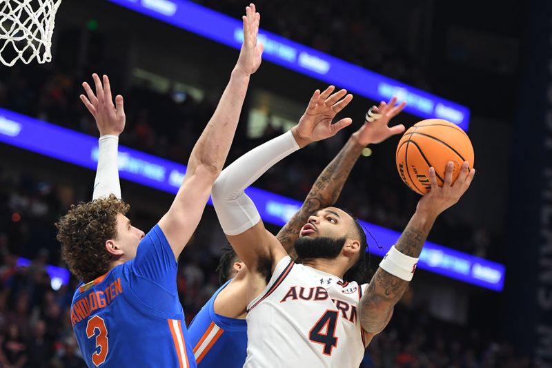 Mar 17, 2024; Nashville, TN, USA;  Auburn Tigers forward Johni Broome (4) shoots against Florida Gators center Micah Handlogten (3) in the first half in the SEC Tournament championship game at Bridgestone Arena. Mandatory Credit: Christopher Hanewinckel-USA TODAY Sports