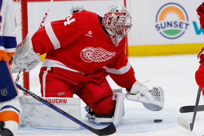 Feb 29, 2024; Detroit, Michigan, USA;  Detroit Red Wings goaltender Alex Lyon (34) makes a save in the first period against the New York Islanders at Little Caesars Arena. Mandatory Credit: Rick Osentoski-USA TODAY Sports