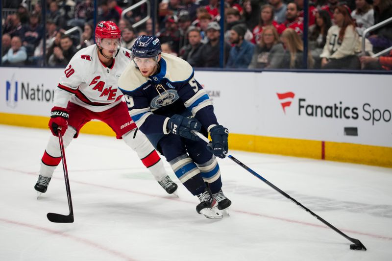 Nov 23, 2024; Columbus, Ohio, USA;  Columbus Blue Jackets right wing Yegor Chinakhov (59) skates with the puck against Carolina Hurricanes center Sebastian Aho (20) in the second period at Nationwide Arena. Mandatory Credit: Aaron Doster-Imagn Images