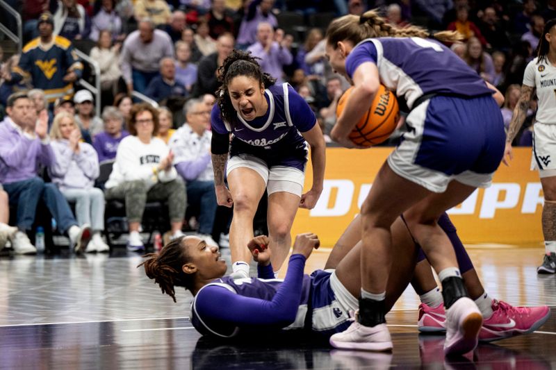 Mar 7, 2025; Kansas City, MO, USA; Kansas State Wildcats guard Zyanna Walker (1) celebrates Kansas State Wildcats forward Kennedy Taylor (12) taking a charge against the West Virginia Mountaineers in the first quarter at T-Mobile Center. Mandatory Credit: Amy Kontras-Imagn Images