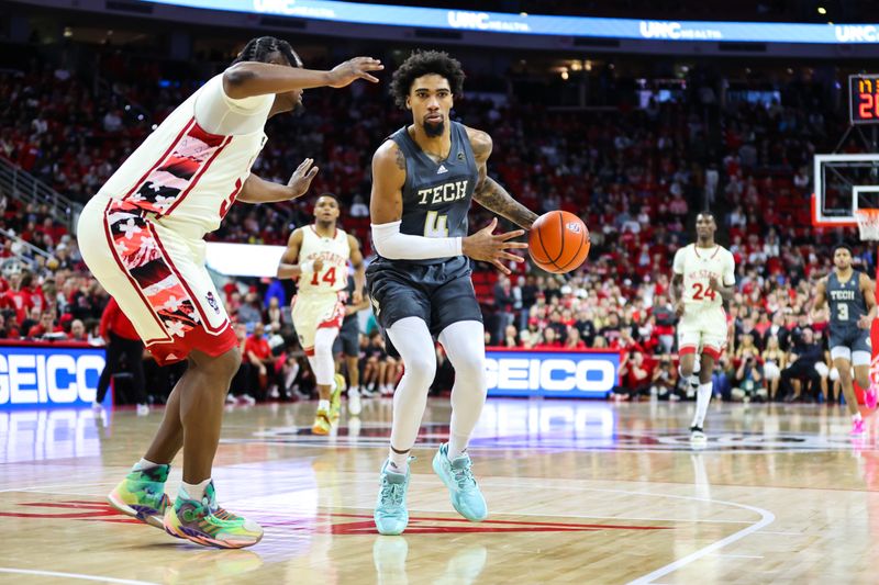 Feb 4, 2023; Raleigh, North Carolina, USA; Georgia Tech Yellow Jackets forward Javon Franklin (4) with the ball guarded by North Carolina State Wolfpack forward D.J. Burns Jr. (30) during the second half of the game at PNC Arena. Mandatory Credit: Jaylynn Nash-USA TODAY Sports