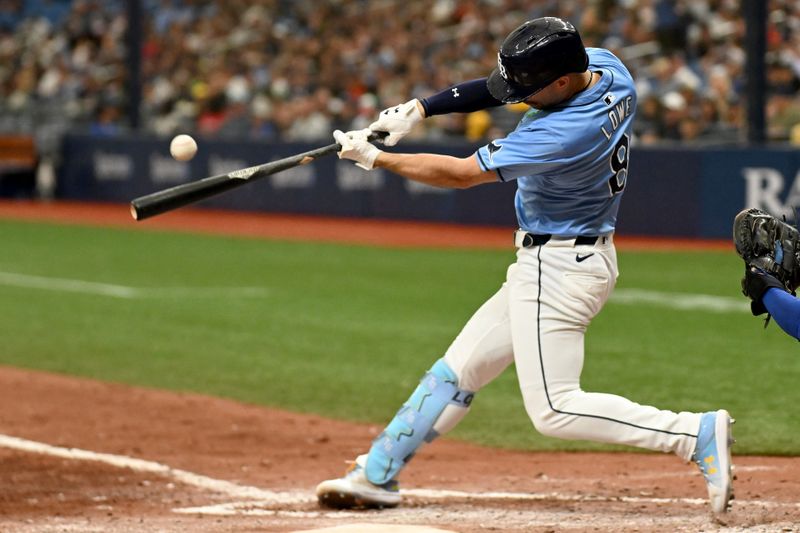 May 26, 2024; St. Petersburg, Florida, USA; Tampa Bay Rays pinch hitter Brandon Lowe (8) hits a 3 run triple in the seventh inning against the Kansas City Royals at Tropicana Field. Mandatory Credit: Jonathan Dyer-USA TODAY Sports
