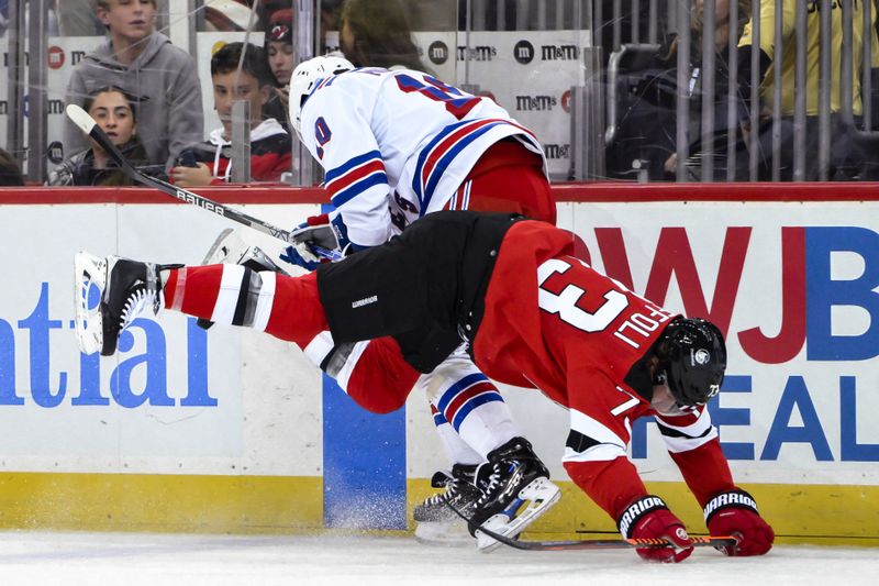 Nov 18, 2023; Newark, New Jersey, USA; New Jersey Devils right wing Tyler Toffoli (73) checks New York Rangers left wing Artemi Panarin (10) during the second period at Prudential Center. Mandatory Credit: John Jones-USA TODAY Sports