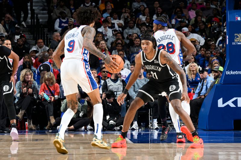 PHILADELPHIA, PA - OCTOBER 16:  Noah Clowney #21 of the Brooklyn Nets  plays defense during the game against the Philadelphia 76ers on October 16, 2024 at the Wells Fargo Center in Philadelphia, Pennsylvania NOTE TO USER: User expressly acknowledges and agrees that, by downloading and/or using this Photograph, user is consenting to the terms and conditions of the Getty Images License Agreement. Mandatory Copyright Notice: Copyright 2024 NBAE (Photo by David Dow/NBAE via Getty Images)