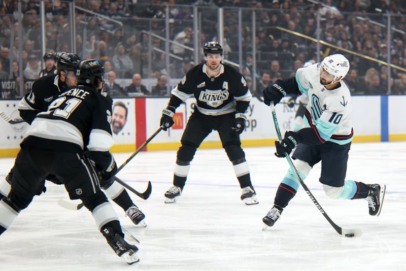 Apr 7, 2025; Los Angeles, California, USA;  Seattle Kraken center Matty Beniers (10) shoots the puck during the first period against the Los Angeles Kings at Crypto.com Arena. Mandatory Credit: Kiyoshi Mio-Imagn Images
