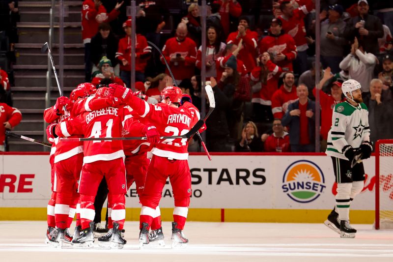 Jan 23, 2024; Detroit, Michigan, USA;  Detroit Red Wings left wing David Perron (57) receives congratulations from teammates after scoring in the first period against the Dallas Stars at Little Caesars Arena. Mandatory Credit: Rick Osentoski-USA TODAY Sports