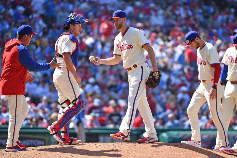 Apr 14, 2024; Philadelphia, Pennsylvania, USA; Philadelphia Phillies pitcher Zack Wheeler (45) hands the ball to manager Rob Thomson (59) after giving up a grands slam hime run against the Pittsburgh Pirates during the sixth inning at Citizens Bank Park. Mandatory Credit: Eric Hartline-USA TODAY Sports