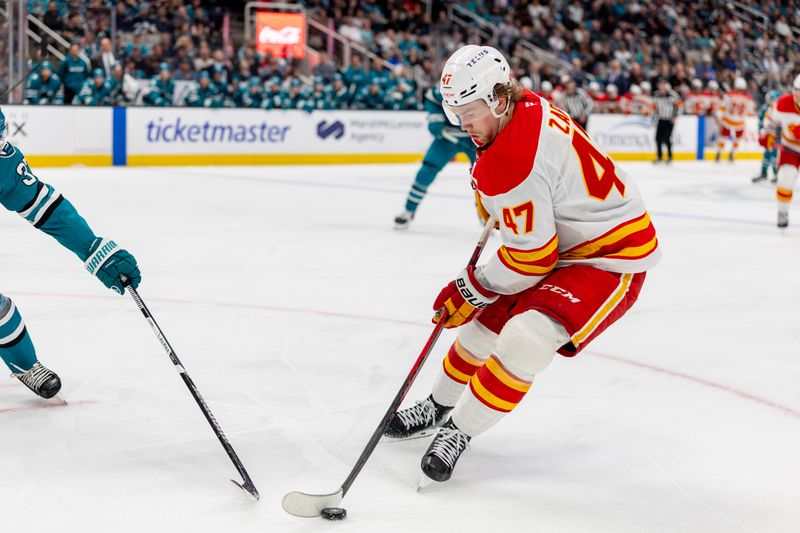 Feb 26, 2026; San Jose, California, USA; Calgary Flames center Connor Zary (47) controls the puck during the third period against the San Jose Sharks at SAP Center at San Jose. Mandatory Credit: Bob Kupbens-Imagn Images