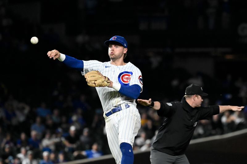 Sep 20, 2023; Chicago, Illinois, USA; Chicago Cubs second baseman Nico Hoerner (2) throws out Pittsburgh Pirates right fielder Joshua Palacios (54) a first base during the ninth inning at Wrigley Field. Mandatory Credit: Matt Marton-USA TODAY Sports