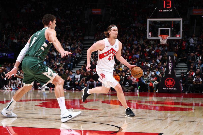 TORONTO, CANADA - JANUARY 6: Kelly Olynyk #41 of the Toronto Raptors dribbles the ball during the game against the Milwaukee Bucks on January 6, 2025 at the Scotiabank Arena in Toronto, Ontario, Canada.  NOTE TO USER: User expressly acknowledges and agrees that, by downloading and or using this Photograph, user is consenting to the terms and conditions of the Getty Images License Agreement.  Mandatory Copyright Notice: Copyright 2025 NBAE (Photo by Vaughn Ridley/NBAE via Getty Images)