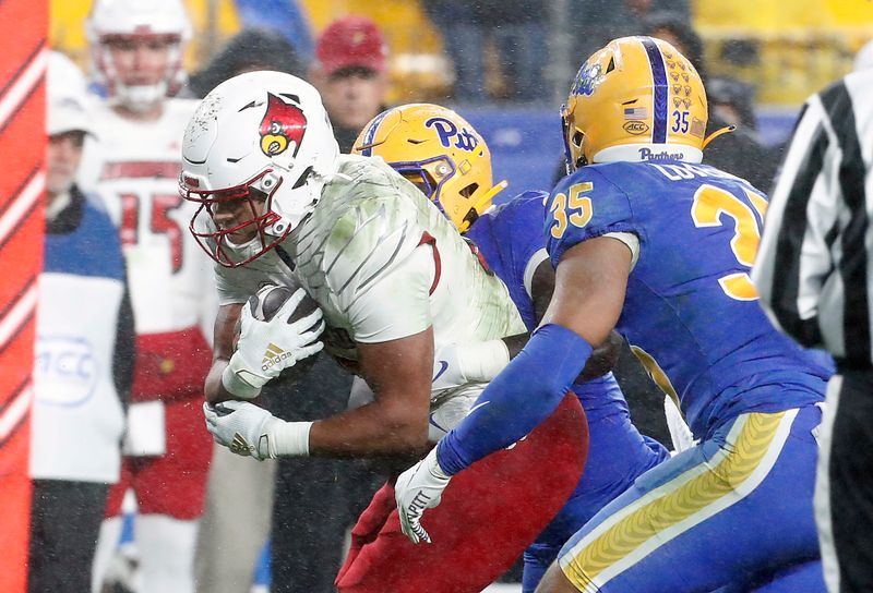 Oct 14, 2023; Pittsburgh, Pennsylvania, USA; Louisville Cardinals running back Isaac Guerendo (23) carries the ball against the Pittsburgh Panthers during the second quarter at Acrisure Stadium. Mandatory Credit: Charles LeClaire-USA TODAY Sports