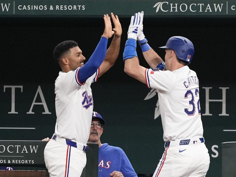 Apr 24, 2024; Arlington, Texas, USA; Texas Rangers left fielder Evan Carter (32) celebrates his home run with second baseman Marcus Semien (2) against the Seattle Mariners during the fourth inning at Globe Life Field. Mandatory Credit: Jim Cowsert-USA TODAY Sports