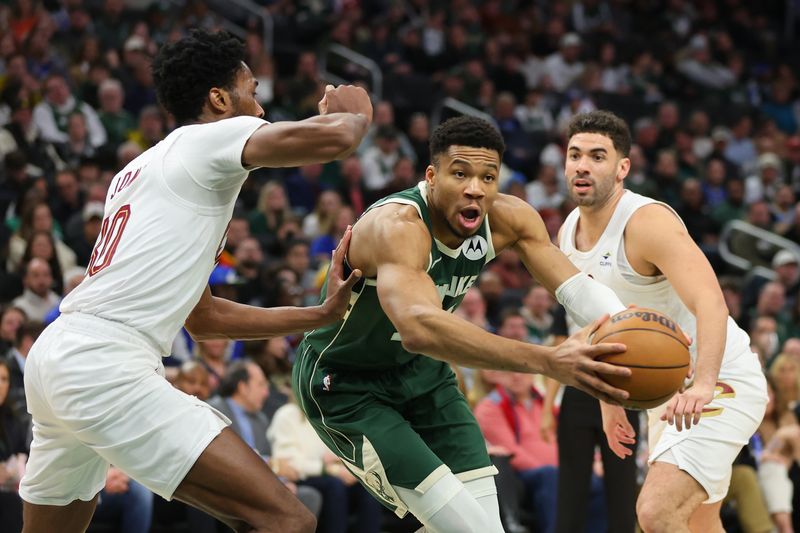 MILWAUKEE, WISCONSIN - JANUARY 24: Giannis Antetokounmpo #34 of the Milwaukee Bucks is defended by Damian Jones #30 of the Cleveland Cavaliers during a game at Fiserv Forum on January 24, 2024 in Milwaukee, Wisconsin. NOTE TO USER: User expressly acknowledges and agrees that, by downloading and or using this photograph, User is consenting to the terms and conditions of the Getty Images License Agreement. (Photo by Stacy Revere/Getty Images)