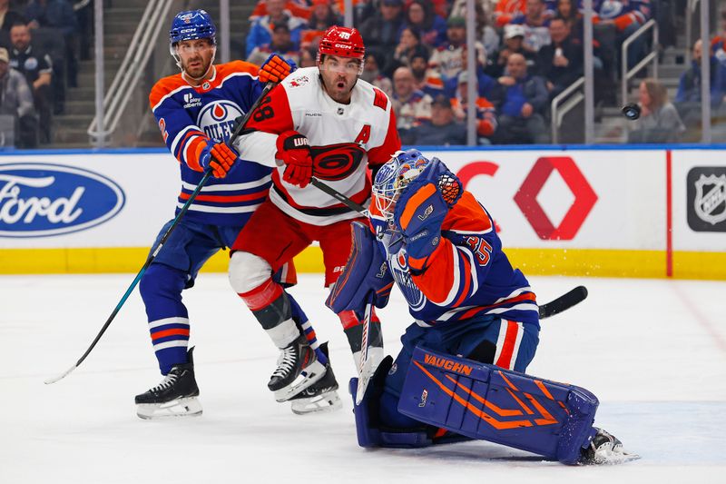 Mar 6, 2026; Edmonton, Alberta, CAN; Carolina Hurricanes forward Jordan Martinook (48) looks for a loose puck in front of Edmonton Oilers goaltender Tristan Jarry (35) during the second period at Rogers Place. Mandatory Credit: Perry Nelson-Imagn Images