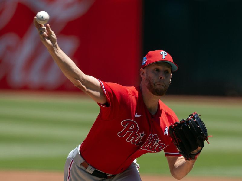 Jun 18, 2023; Oakland, California, USA; Philadelphia Phillies starting pitcher Zack Wheeler (45) delivers a pitch against the Oakland Athletics during the first inning at Oakland-Alameda County Coliseum. Mandatory Credit: D. Ross Cameron-USA TODAY Sports