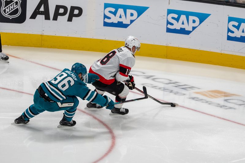 Nov 27, 2024; San Jose, California, USA; Ottawa Senators center Tim Stützle (18) controls the puck against San Jose Sharks defenseman Jake Walman (96) during the second period at SAP Center at San Jose. Mandatory Credit: Neville E. Guard-Imagn Images