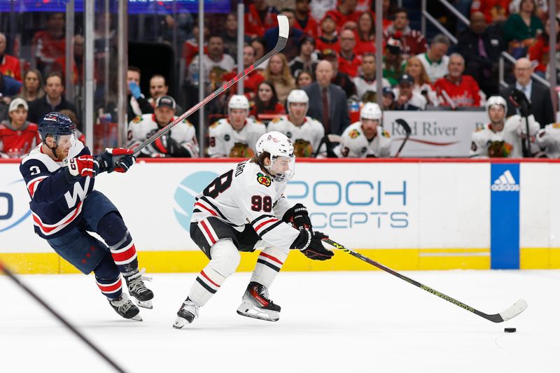 Mar 9, 2024; Washington, District of Columbia, USA; Chicago Blackhawks center Connor Bedard (98) skates with the puck as Washington Capitals defenseman Nick Jensen (3) chases in the second period at Capital One Arena. Mandatory Credit: Geoff Burke-USA TODAY Sports