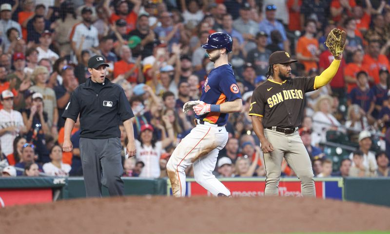 Sep 10, 2023; Houston, Texas, USA; San Diego Padres third baseman Eguy Rosario (5) reacts and Houston Astros right fielder Kyle Tucker (30) runs to third base on his second triple in the same inning during the sixth inning at Minute Maid Park. Mandatory Credit: Troy Taormina-USA TODAY Sports