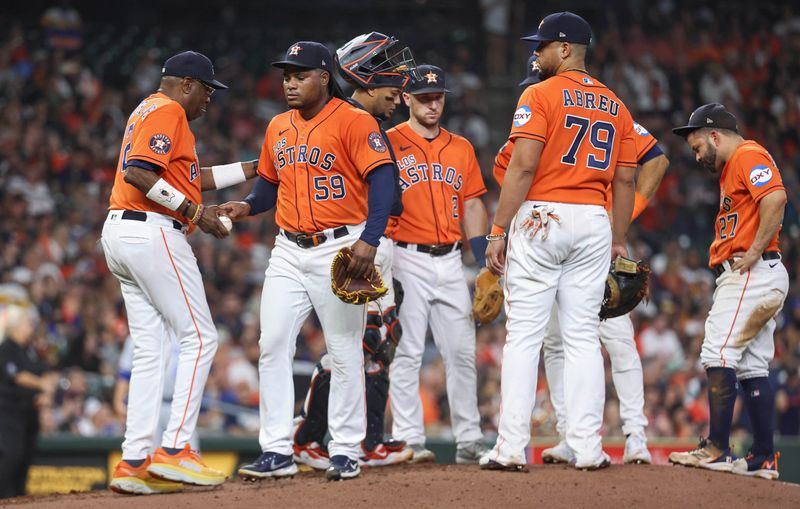 Sep 22, 2023; Houston, Texas, USA; Houston Astros starting pitcher Framber Valdez (59) hands the ball to manager Dusty Baker Jr. (12) during a pitching change in the sixth inning against the Kansas City Royals at Minute Maid Park. Mandatory Credit: Troy Taormina-USA TODAY Sports