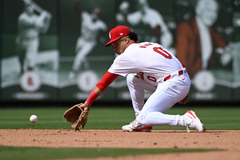 Apr 20, 2024; St. Louis, Missouri, USA; St. Louis Cardinals shortstop Masyn Winn (0) fields a ground ball by the Milwaukee Brewers in the seventh inning at Busch Stadium. Mandatory Credit: Joe Puetz-USA TODAY Sports