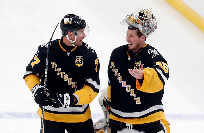 Feb 18, 2024; Pittsburgh, Pennsylvania, USA;  Pittsburgh Penguins center Jeff Carter (77) and Pittsburgh Penguins goaltender Tristan Jarry (35) talk as the return to the ice after a time-out against the Los Angeles Kings during the second period at PPG Paints Arena. Los Angeles won 2-1.  Mandatory Credit: Charles LeClaire-USA TODAY Sports