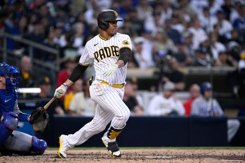 Aug 4, 2023; San Diego, California, USA; San Diego Padres left fielder Juan Soto (22) hits a single against the Los Angeles Dodgers during the sixth inning at Petco Park. Mandatory Credit: Orlando Ramirez-USA TODAY Sports