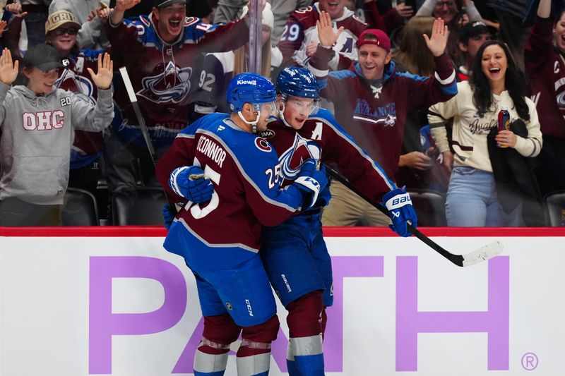 Nov 9, 2024; Denver, Colorado, USA; Colorado Avalanche defenseman Cale Makar (8) celebrates his goal with right wing Logan O'Connor (25) in the second period against the Carolina Hurricanes at Ball Arena. Mandatory Credit: Ron Chenoy-Imagn Images