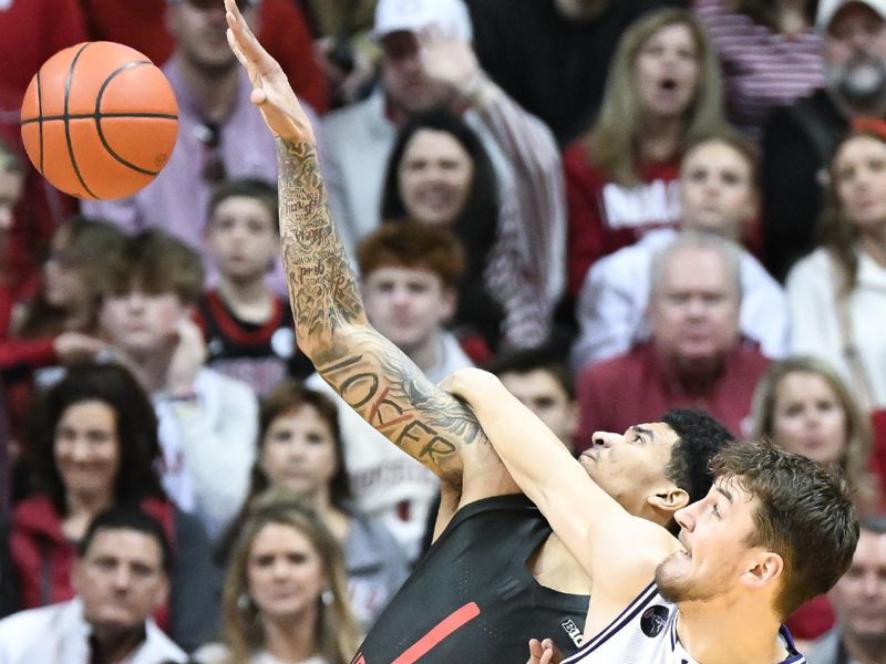 Feb 18, 2024; Bloomington, Indiana, USA;  Northwestern Wildcats forward Luke Hunger (33) fouls Indiana Hoosiers center Kel'el Ware (1) during the second half at Simon Skjodt Assembly Hall. Mandatory Credit: Robert Goddin-USA TODAY Sports