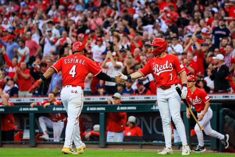 May 17, 2025; Cincinnati, Ohio, USA; Cincinnati Reds third baseman Santiago Espinal (4) high fives first baseman Spencer Steer (7) after scoring on a double hit by  designated hitter Austin Hays (not pictured) in the sixth inning against the Cleveland Guardians at Great American Ball Park. Mandatory Credit: Katie Stratman-Imagn Images
