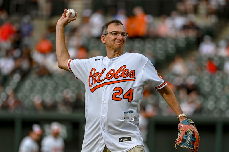 Jun 11, 2024; Baltimore, Maryland, USA;  Rob Sharps, CEO and President of T. Rowe Price, throws a ceremonial first pitch before the game against the Atlanta Braves  at Oriole Park at Camden Yards. Mandatory Credit: Tommy Gilligan-USA TODAY Sports