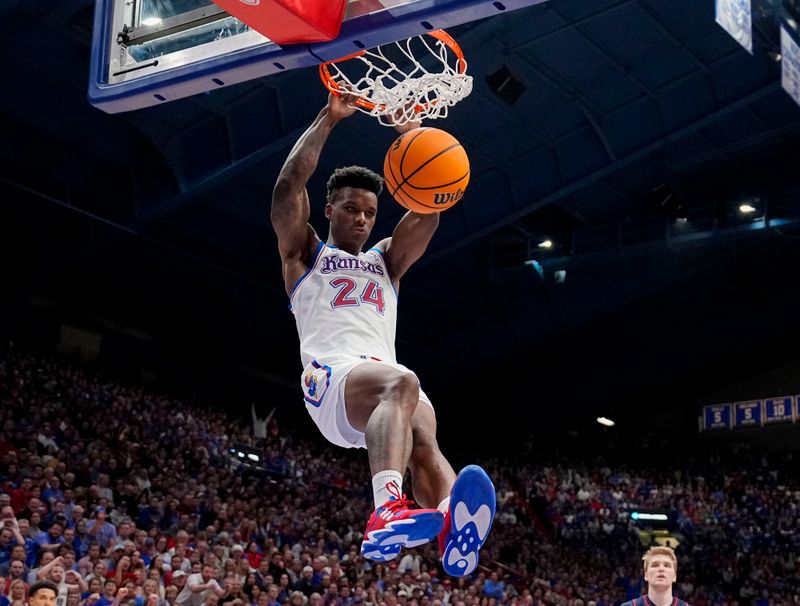 Dec 1, 2023; Lawrence, Kansas, USA; Kansas Jayhawks forward K.J. Adams Jr. (24) dunks the ball against the Connecticut Huskies during the second half at Allen Fieldhouse. Mandatory Credit: Jay Biggerstaff-USA TODAY Sports